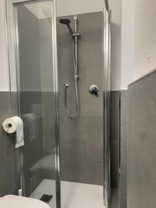 a shower with a glass door in a bathroom at Appartamento La Torre in Predazzo
