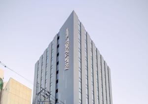 a tall grey building with the name on it at Tokyu Stay Sapporo in Sapporo
