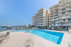 a swimming pool in front of a apartment building at Compass Point 303 in Gulf Shores