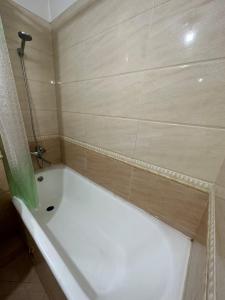 a bath tub in a bathroom with a shower at Your home in UB in Ulaanbaatar