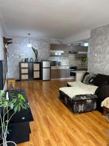a living room with a couch and a kitchen at Your home in UB in Ulaanbaatar