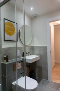 a bathroom with a sink and a mirror at Combie Lane Apartment in Oban