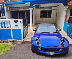 a blue car parked in front of a house at 611 Navy House Seremban Homestay Seremban Town in Seremban