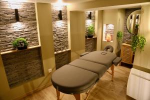 a salon with a massage table in a room at love room gold - les delices rooms in Angers
