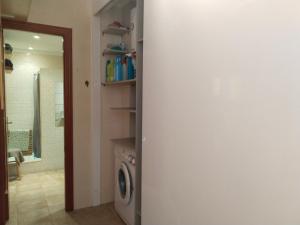 a bathroom with a washer and dryer in a room at Acogedor estudio con vistas al mar 1ªLínea in Bellreguart