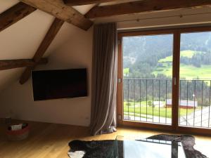 a bedroom with a large window with a view of a mountain at Tgesa Antgerna in Salouf