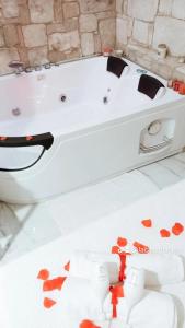 a white bath tub with red hearts on the floor at B&B La casa di Anna in Teano