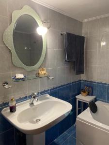 a bathroom with a sink and a mirror and a toilet at Country house in Galatas