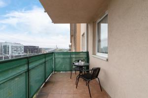 a balcony with a table and chairs on it at Cozy Apartment with Balcony Chmieleniec by Renters in Krakow