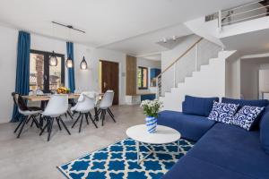 a living room with a blue couch and a table at Villa Lomida Opatija in Opatija