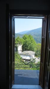 an open window with a view of a yard at Antonis Tasios Guesthouse in Zagora