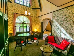 a room with a couch and a table and a bed at Restaurant & Hotel Traumerei in Hakuba