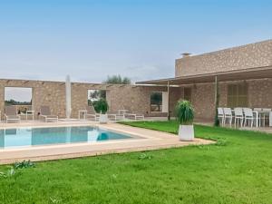 a house with a swimming pool in a yard at Can Mosca in Cala Mendia