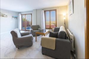 a living room with two chairs and a couch at Casa Meli Finestrat in Finestrat