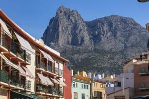 a mountain in the background of a city with buildings at Casa Meli Finestrat in Finestrat