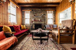 a living room with couches and a fireplace at Halatsogiannis Mansion in Palaios Panteleimon