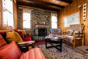 Halatsogiannis Mansion في بالايوس بانتليمون: غرفة معيشة مع أريكة ومدفأة