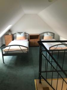 a room with two bunk beds in a attic at Pension Zur Linde in Berlstedt