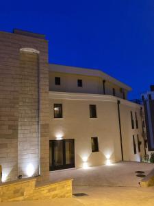 a large white building at night at Studio Apartman Dalia in Budva