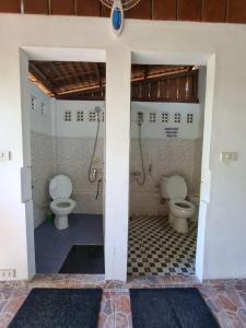 a bathroom with two toilets in a room at Treetop Guesthouse and Bungalows in Sabong