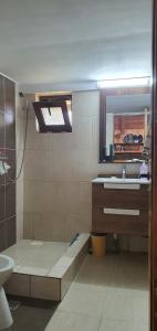 a bathroom with a sink and a mirror at La Unchesu in Gorgova