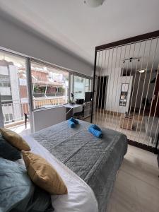 a bedroom with a bed and a large window at Athena Βright & New Studio - 25' walk to the Acropolis in Athens