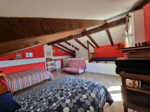 a attic room with a bed and a couch at Casa Monte Bracco in Rifreddo