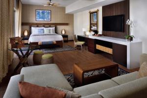 a hotel room with a bed and a desk at Lapita, Dubai Parks and Resorts, Autograph Collection in Dubai
