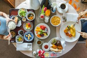 a table with plates of food on top of it at The Okura Prestige Bangkok in Bangkok