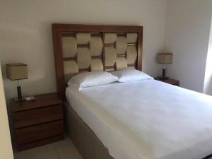 a bedroom with a large white bed with two lamps at Ponto Horizonte Manzanillo. Best place in Manzanillo!!! Luxury beach front condo, gorgeous views!! Best place you can stay!with up to 8 people. in Manzanillo