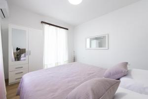 Ein Bett oder Betten in einem Zimmer der Unterkunft Apartment Iva