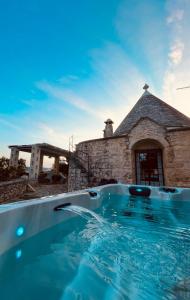 a large swimming pool in front of a building at TRULLI DI ZIA TATA in Locorotondo