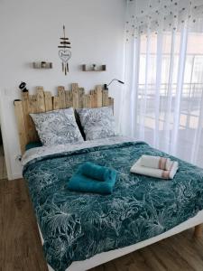 łóżko z dwiema poduszkami w sypialni w obiekcie L'appart' du bord de mer 150m de la plage w mieście Lion-sur-Mer +21 zdjęć