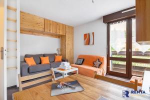a living room with a couch and a table at Le Capcir - Cosy et lumineux pour se ressourcer in Font-Romeu-Odeillo-Via
