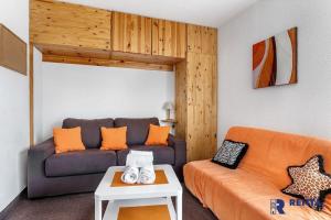 ein Wohnzimmer mit einem Sofa und einem Tisch in der Unterkunft Le Capcir - Cosy et lumineux pour se ressourcer in Font Romeu Odeillo Via