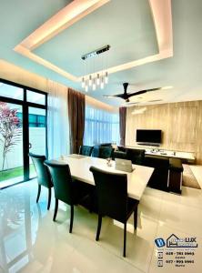 a dining room with a table and chairs at Batu Ferringhi Luxurious Modern Designed 5BR House in Batu Ferringhi