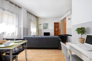 a living room with a couch and a table at Apartments Sata Park Guell Area in Barcelona