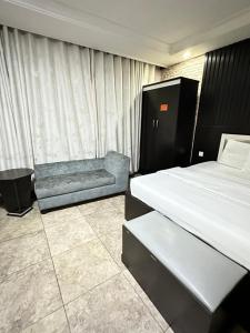 A bed or beds in a room at Msquare Hotel GRA