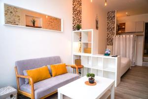 a living room with a couch and a table at L'atelier • Cosy • Élégant in Déols