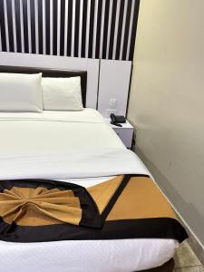 A bed or beds in a room at Msquare Hotel GRA