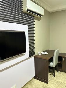 A television and/or entertainment centre at Msquare Hotel GRA