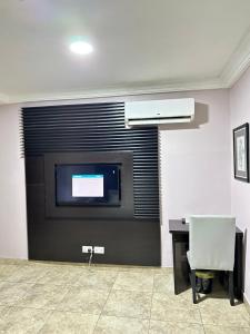 A television and/or entertainment centre at Msquare Hotel GRA