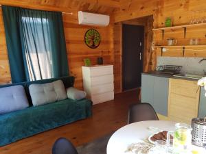 a living room with a green couch and a table at Sea You Soon w Sztutowie in Sztutowo
