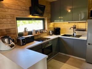 a kitchen with a sink and a counter top at Mazurski Domek - Wake Up Home Ogonki in Ogonki