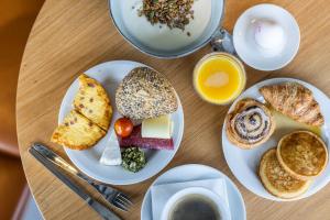 a table topped with plates of breakfast foods and coffee at Airport Hotel, Billund in Billund