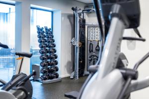 a gym with cardio equipment at Billund Airport Hotel in Billund