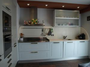 a kitchen with white cabinets and a sink at Orio - Acogedor - WIFI in Orio