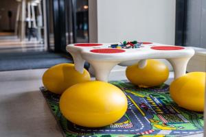 a table sitting on top of yellow balls on a rug at Airport Hotel, Billund in Billund