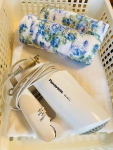 a laundry basket with a hair dryer and towels at Osaka MISAKI Traditional Japanese house 2-6 ppl near station in Osaka