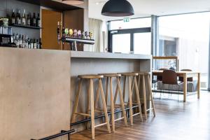 a bar with a row of stools at a counter at Airport Hotel, Billund in Billund